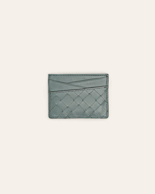 Light blue woven cardholder on a light beige background