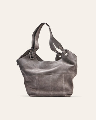 Gray leather suede handbag on a light gray background