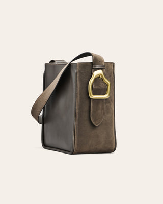 Cala Jade Masago Ebony suede brown leather bag with a gold buckle on a beige background