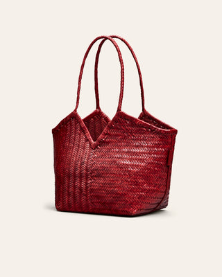 Red woven handbag on a beige background