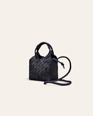 navy nubuck woven handbag on a light beige background