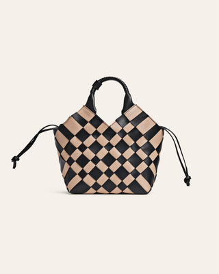 Checkered handbag with black and beige pattern on a light beige background