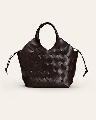 A handwoven brown cowhide shoulder bag with a solid pattern, featuring brass hardware and a magnet closure.