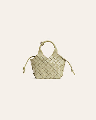 Woven light green handbag on a light beige background