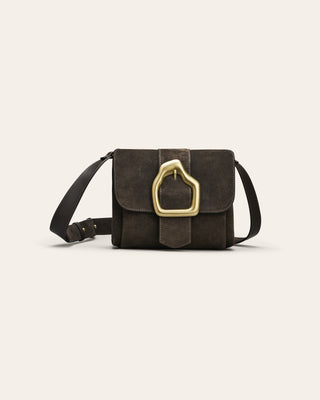 Brown suede shoulder bag with gold buckle on beige background