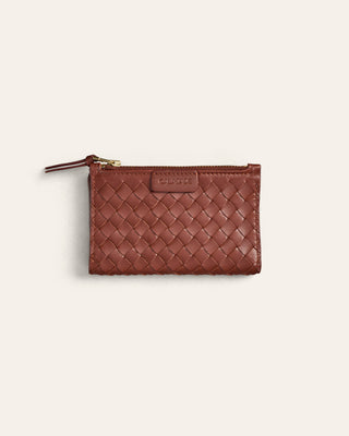 Brown woven wallet with a gold zipper on a light beige background