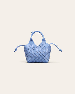 Cala Jade Blue woven handbag on a light beige background