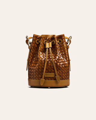Brown woven bucket bag on a white background
