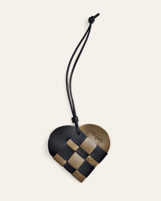 Cala Jade heart-shaped green and black leather bag charm on a beige background