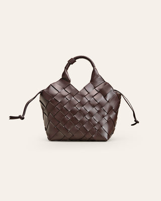 Cala Jade  handbraided, brown Misu shoulder bag with a shoulder strap, zipper closure on a beige background