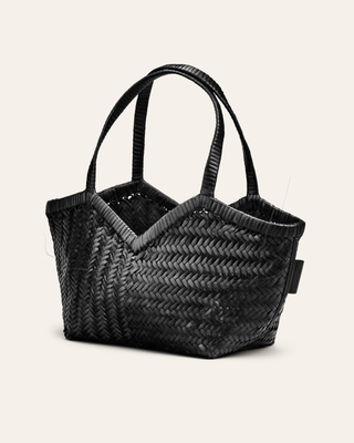 Cala Jade Black woven handbag on a light beige background seen from the side