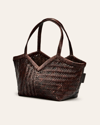 Cala Jade Brown woven handbag on a light beige background seen from the side