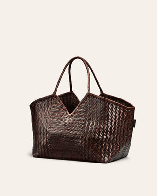 Cala Jade umber brown woven brown bag on a beige background