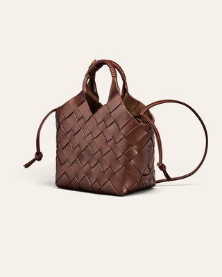 A brown woven shoulder bag in 100% leather on a beige background used for product image