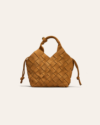 A beige nubuck woven leather bag on a beige background