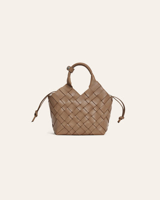 Dark beige woven handbag on a light beige background