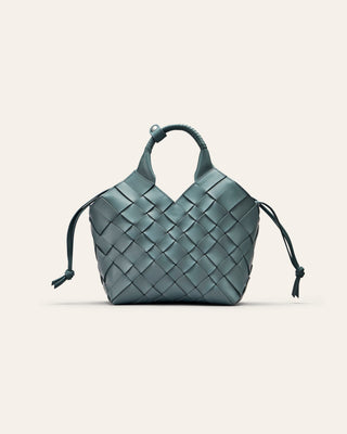 A blue woven leather bag on a beige background
