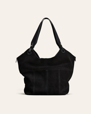 Cala Jade Black suede handbag on a beige background