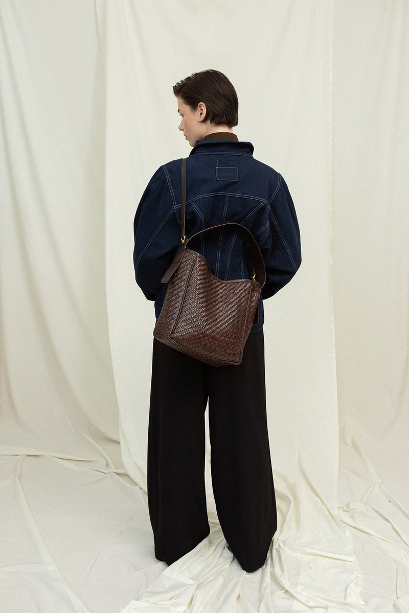 Cala Jade IWA umber leather bag on model